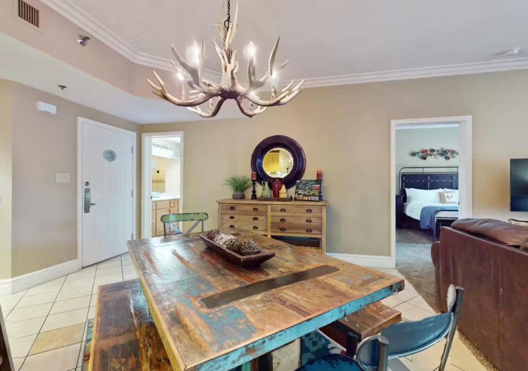 Gather around your rustic dining table beneath the striking antler chandelier for memorable meals with family and friends.