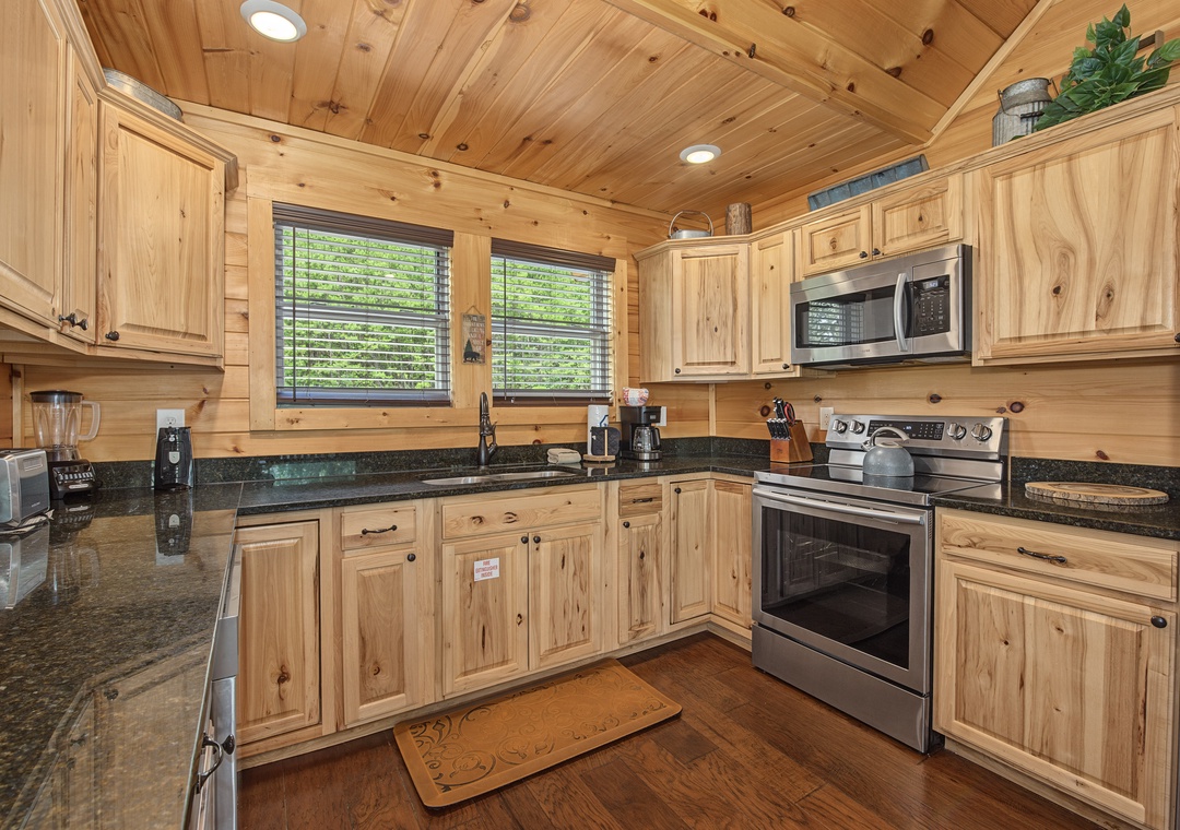 Step into your cozy mountain kitchen, where warm wood tones and all the comforts of home await. Prepare meals surrounded by rustic charm, complete with modern appliances and plenty of counter space—perfect for morning coffee or evening gatherings.