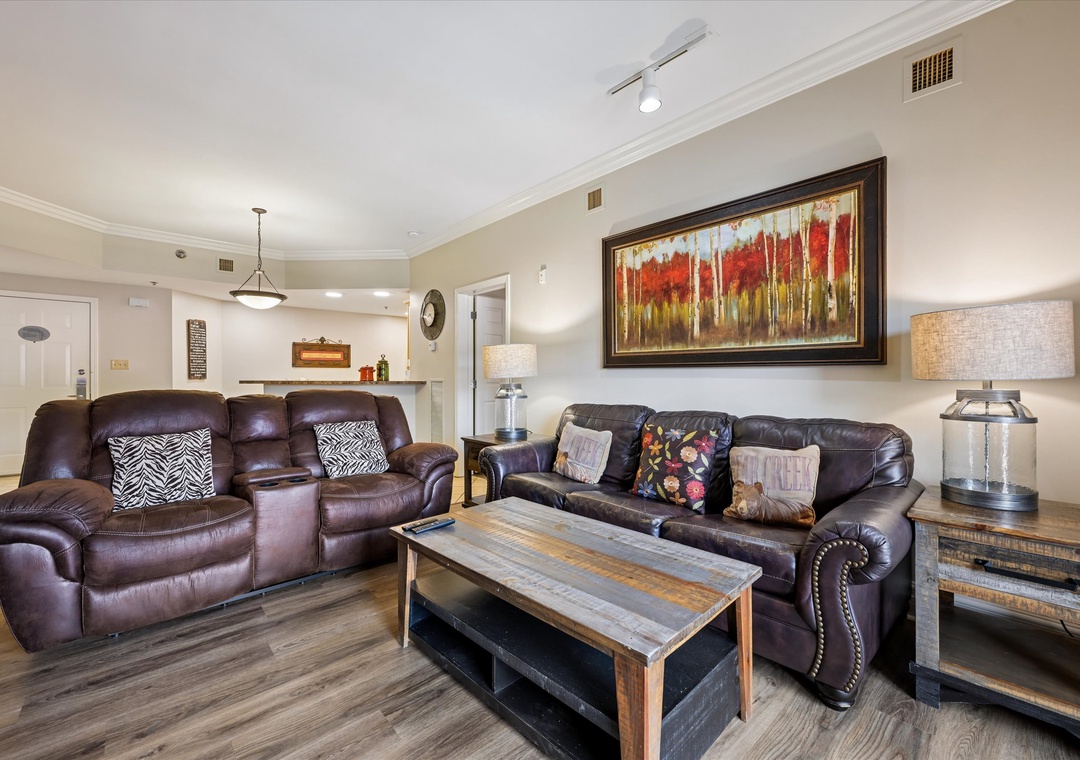 Sink into plush leather recliners and unwind in your spacious living area, where warm lighting creates the perfect atmosphere for relaxation.