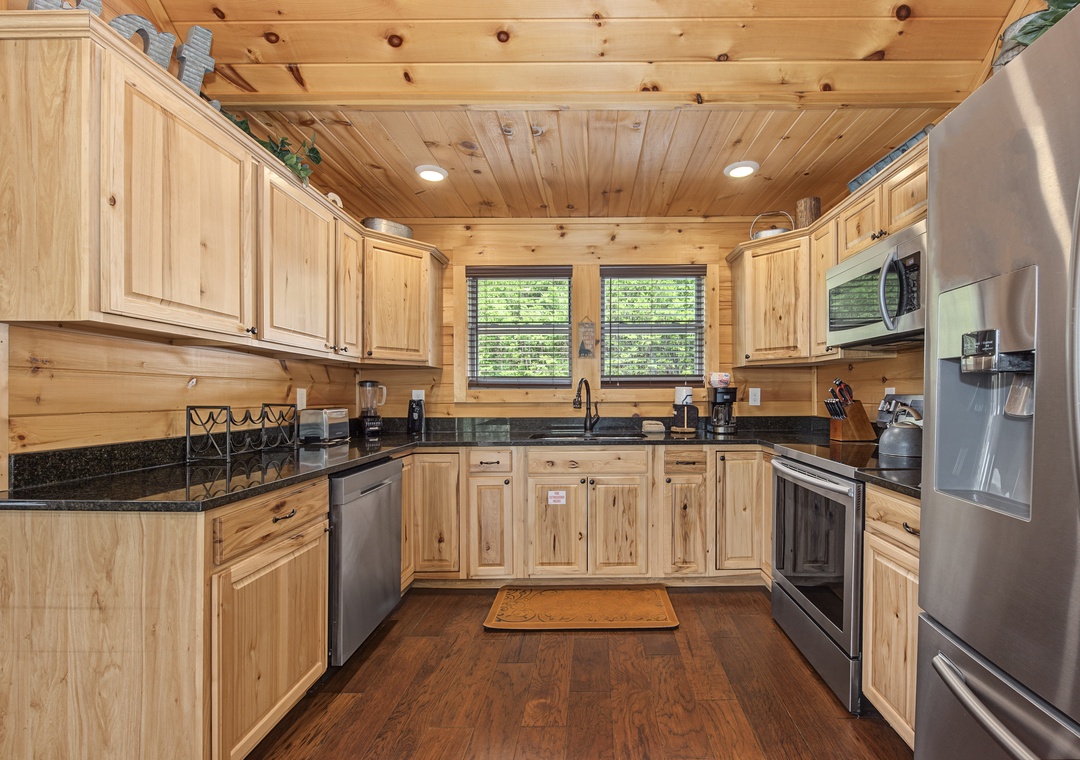 Your fully equipped mountain kitchen features warm wood cabinets, granite counters, and all the stainless steel appliances you need to whip up home-cooked meals during your stay.