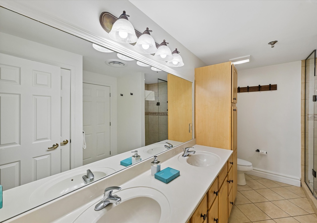 Spacious bathroom with double vanity and modern lighting creates your perfect morning routine space.