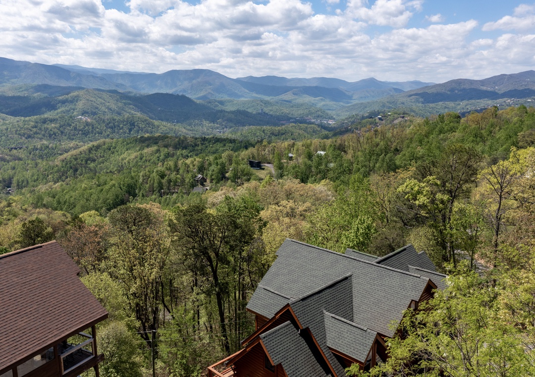 Stunning mountain vistas stretch endlessly from this elevated property, surrounded by lush Appalachian forest.