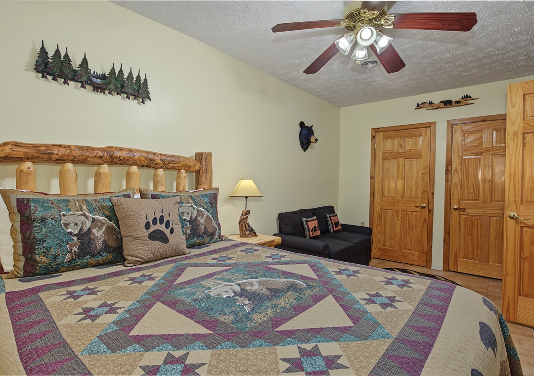 Settle into your cozy cabin-style retreat with rustic log furniture, charming woodland accents, and a plush quilted bed that invites restful nights after your mountain adventures.