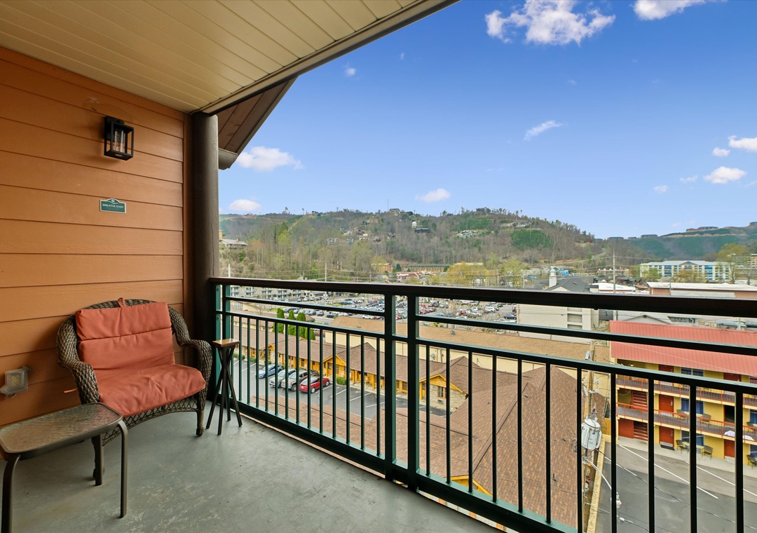 Unwind on your private balcony with mountain views, where comfortable seating invites you to savor morning coffee or evening relaxation.