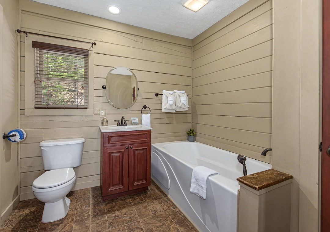 Unwind in your private bathroom featuring a deep soaking tub, perfect for relaxing after your adventures.