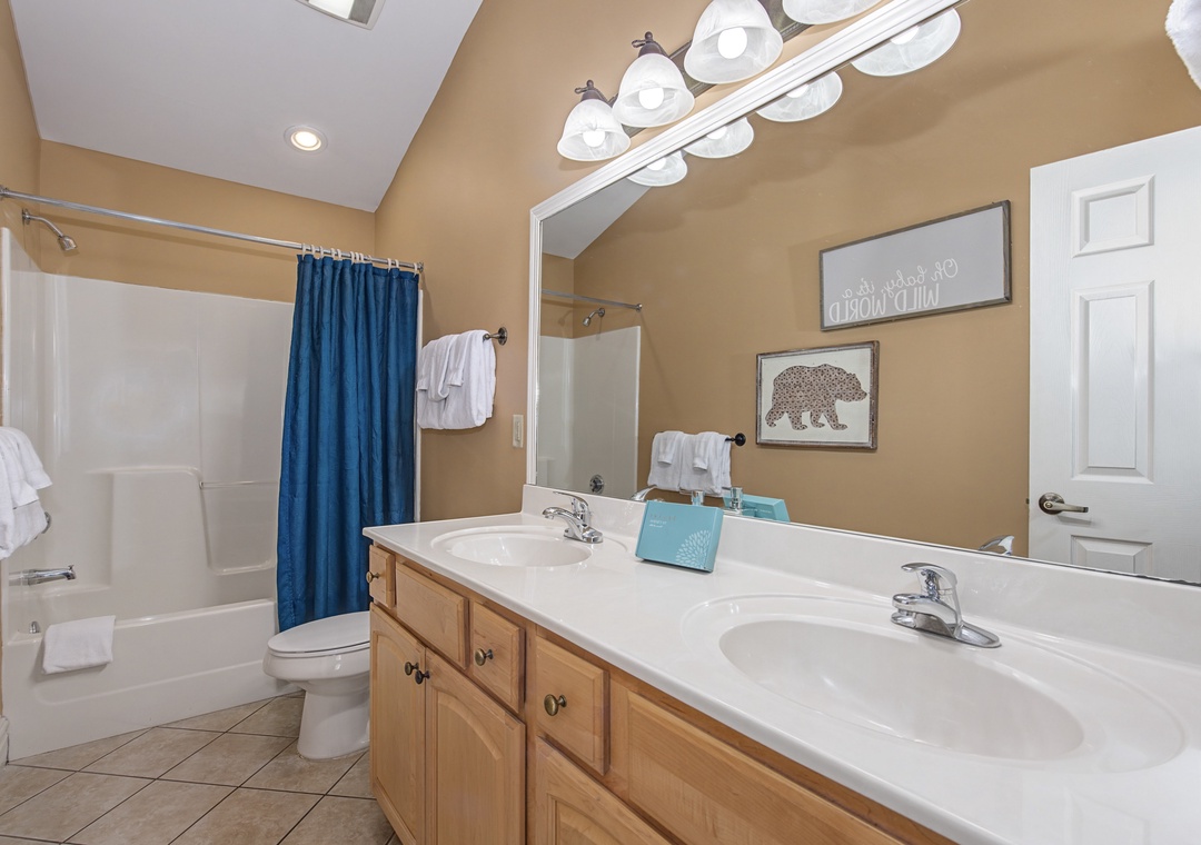 Your spacious bathroom features dual sinks, fresh towels, and a relaxing tub-shower combo for ultimate convenience.