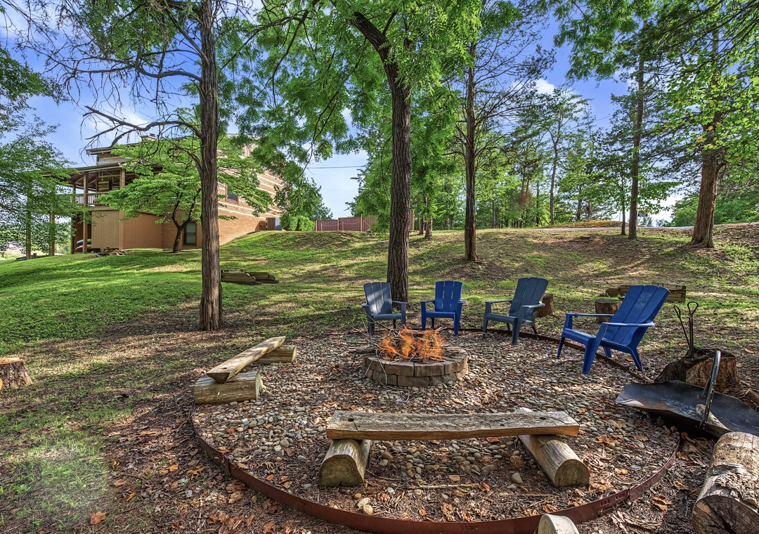 Gather around a cozy fire pit with Adirondack chairs and log benches, nestled under tall trees on spacious grounds—perfect for s'mores and storytelling under the stars.
