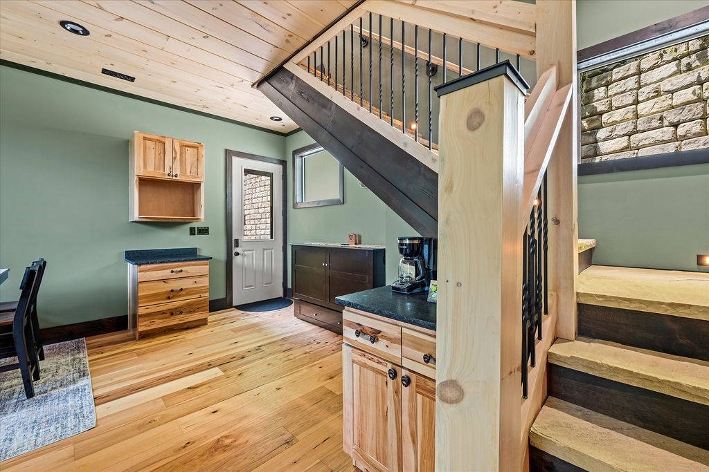 Warm wood tones and soaring ceilings create an open, airy space where you'll love cooking and relaxing. Your cozy loft adds extra charm to this inviting retreat.
