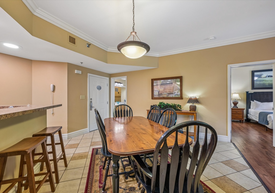 Gather around this welcoming dining space where warm wooden tones and comfortable seating create the perfect setting for your family meals.