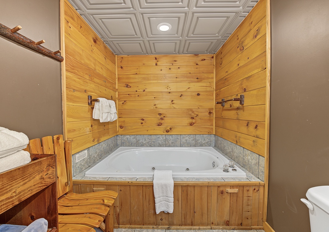 Sink into your own jetted tub, surrounded by warm wood paneling and rustic charm—a perfect retreat after a day of exploring.