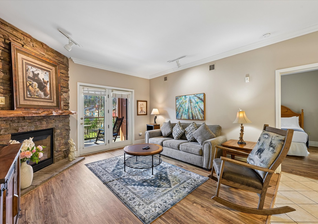 Relax in your cozy living room with stone fireplace, comfortable seating, and warm lighting that creates the perfect atmosphere for unwinding.