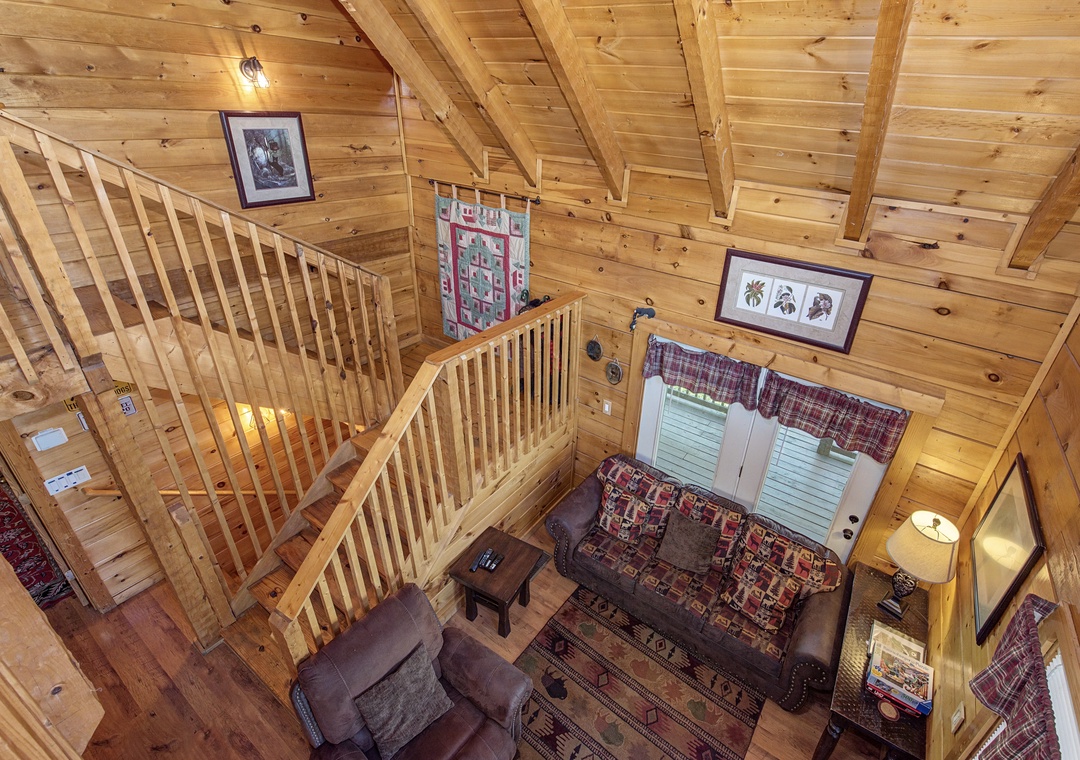 Cozy up in this rustic loft where warm wood surrounds you, plaid patterns invite relaxation, and charming artwork creates your perfect mountain retreat.
