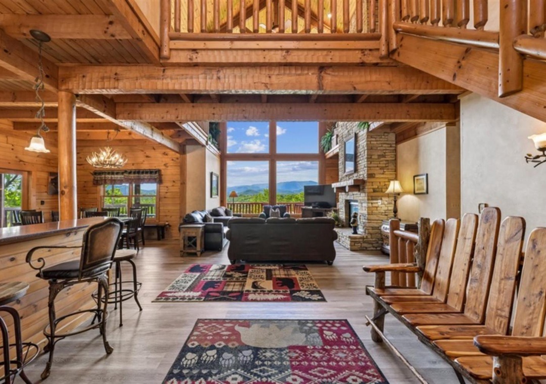 Step into your mountain retreat where soaring wood beams, a grand stone fireplace, and sweeping vistas through floor-to-ceiling windows create the perfect backdrop for unforgettable gatherings.