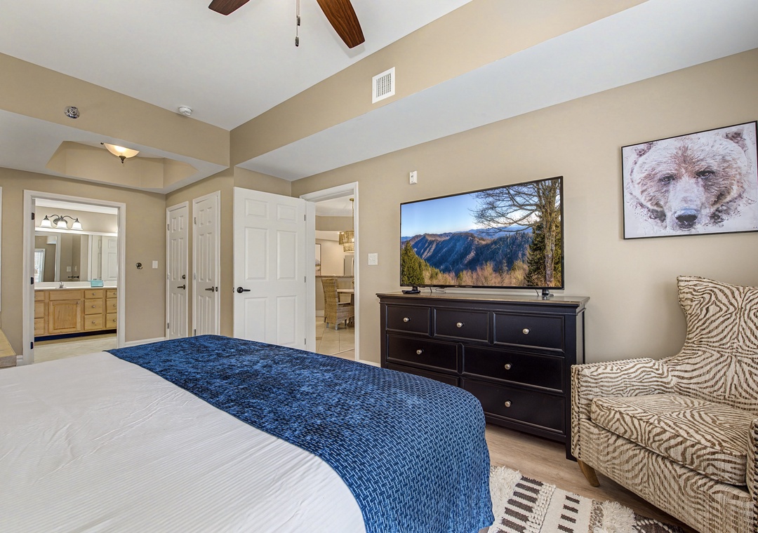 Your spacious bedroom offers plush bedding, cozy seating, and mountain views on the large TV for perfect evening relaxation.