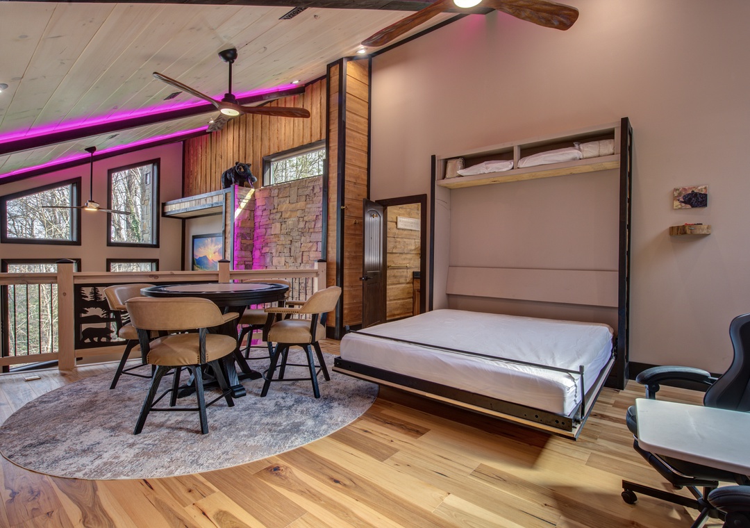 Your modern studio transforms with a Murphy bed that folds away, revealing spacious living with dining area and vibrant mood lighting for ultimate flexibility.