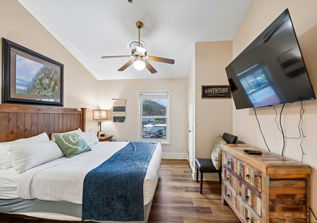 Drift into peaceful dreams in your cozy retreat, where rustic charm meets modern comfort beneath a gentle ceiling fan.