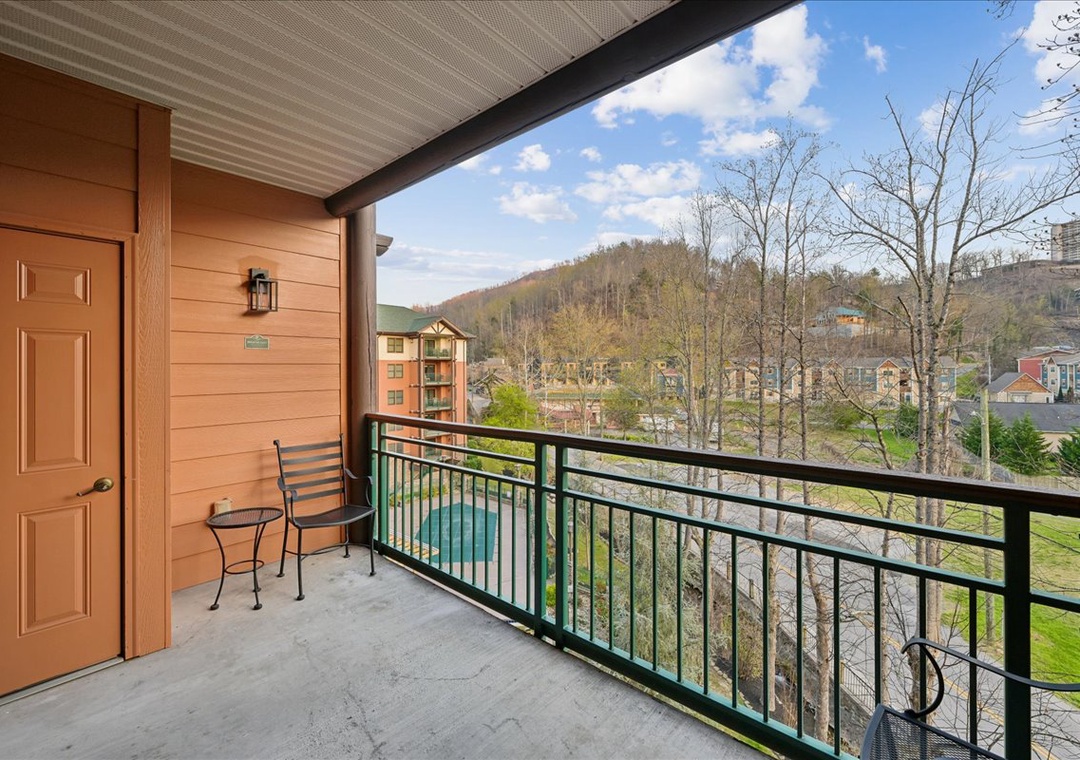 Step onto your private balcony and breathe in the fresh mountain air while enjoying stunning views of rolling hills and the sparkling pool below.