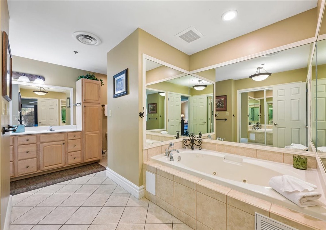 Unwind in your spacious master bathroom with dual vanities, soaking tub, and separate shower—perfect for relaxing after busy vacation days.