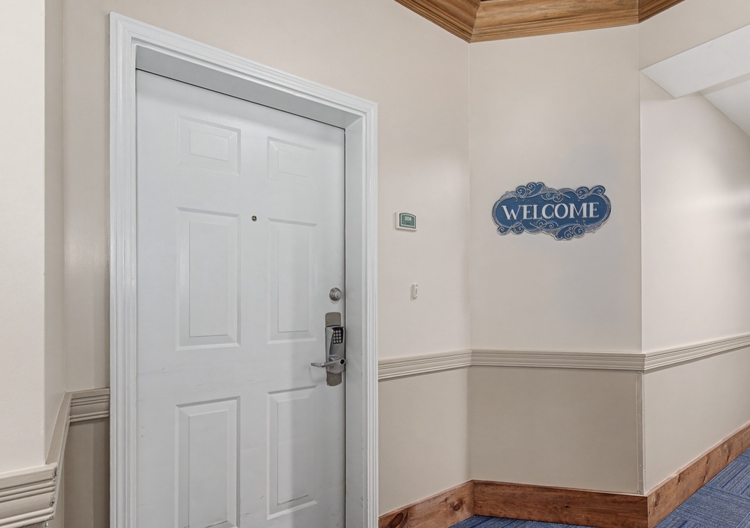 Your home away from home awaits behind this welcoming entrance, featuring elegant molding and warm wood accents that set the tone for your stay.