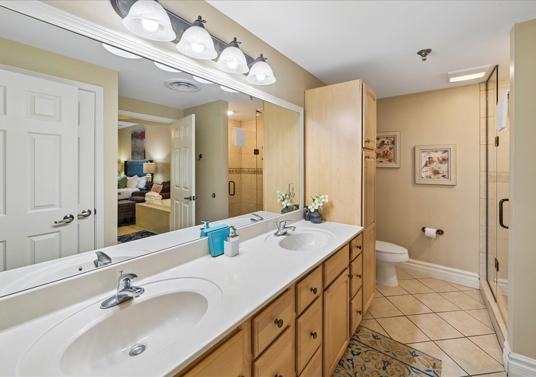 Your spacious master bathroom features dual vanities with ample counter space, perfect for your morning routine together.