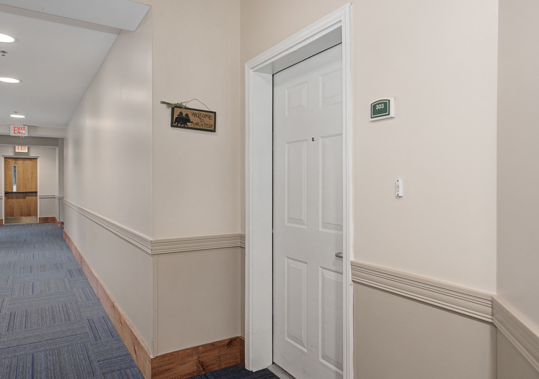 A welcoming hallway leads to your private retreat, with thoughtful touches like the charming welcome sign creating an inviting atmosphere for your stay.
