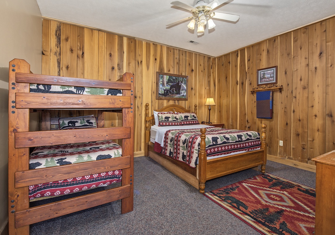Rustic charm meets cozy comfort in this cabin-style bedroom with handcrafted wood beds and warm knotty pine walls. Your group will rest easy with flexible sleeping arrangements and authentic mountain lodge character.