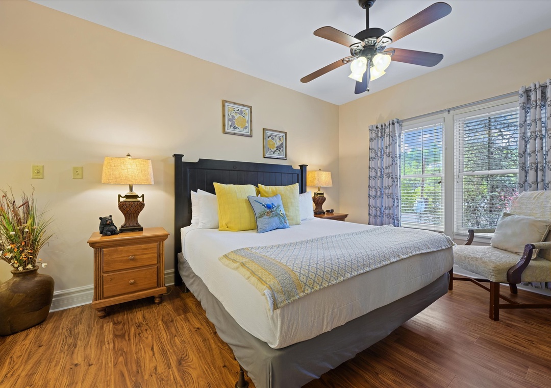 Settle into your cozy bedroom where soft linens, warm wood floors, and a gentle ceiling fan create your perfect retreat after a day of adventure.