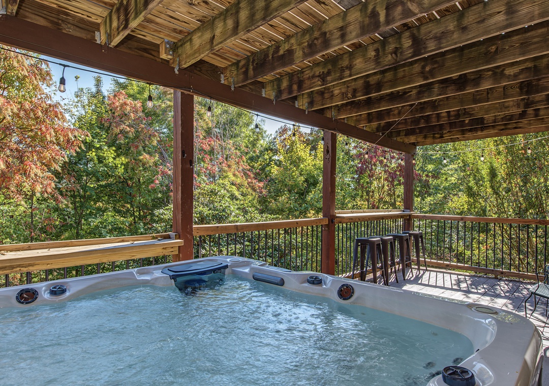 Soak in the bubbling hot tub on your private deck, surrounded by vibrant autumn foliage and fresh mountain air—your perfect retreat after a day of adventure.