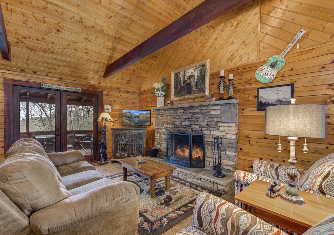 Curl up by your crackling stone fireplace while soaking in forest views through tall windows in this cozy cabin retreat.