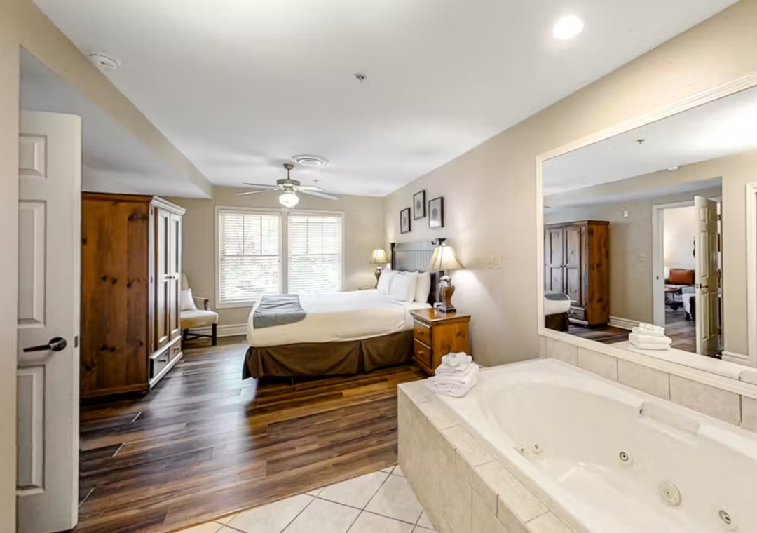 Your romantic suite features a king bed and luxurious jetted tub for two, creating the perfect intimate retreat.