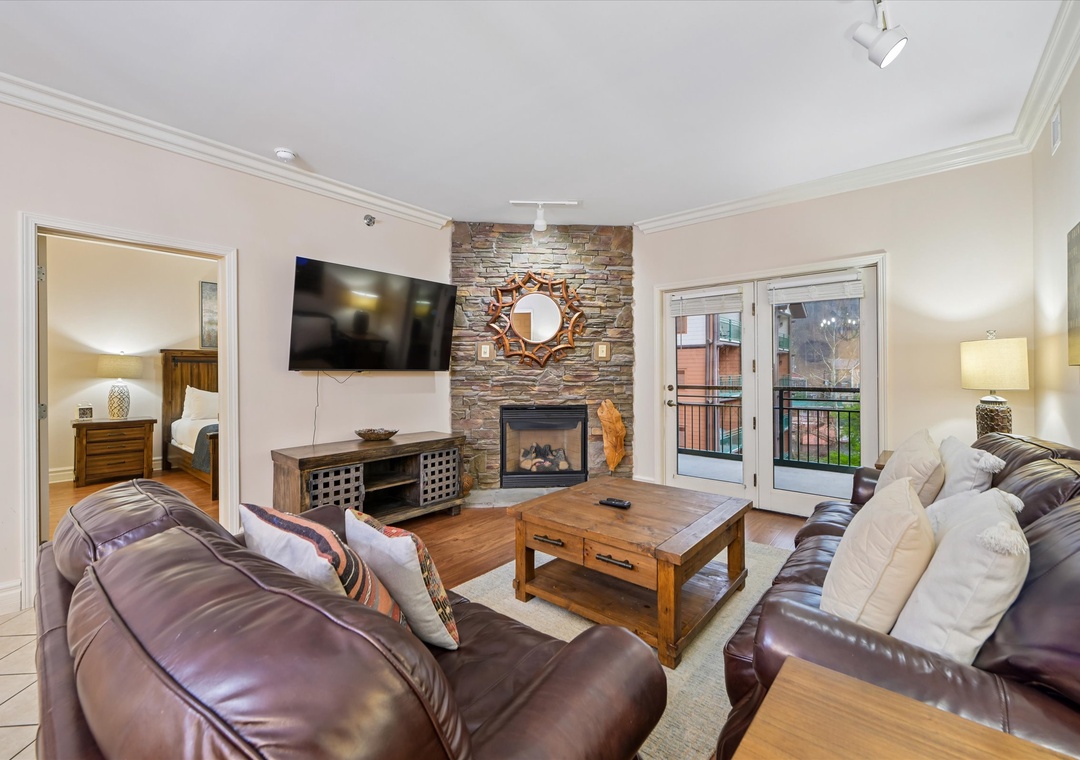 Sink into plush leather seating while the stone fireplace creates a cozy glow for your evening relaxation.