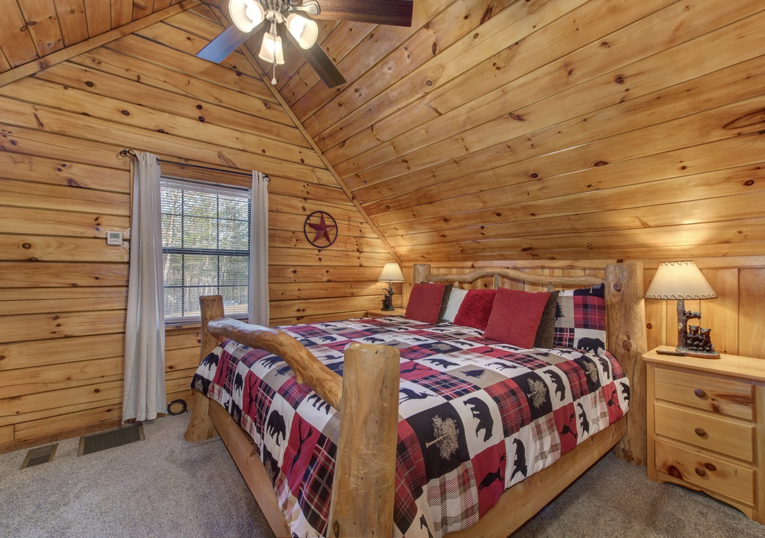 Drift off in this cozy log bedroom where rustic charm meets comfort. Your plaid bedding and warm wood surroundings create the perfect mountain retreat.