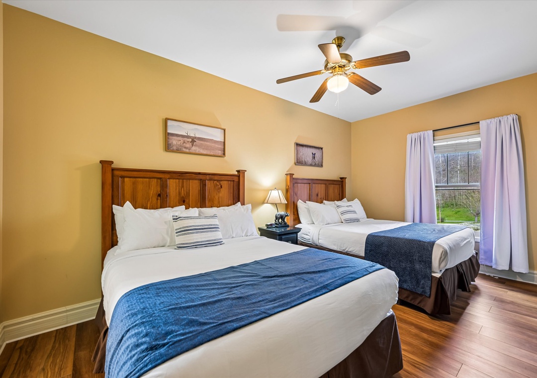 Unwind in this cozy twin bedroom with rustic charm, where warm wood tones and crisp linens create your perfect retreat.