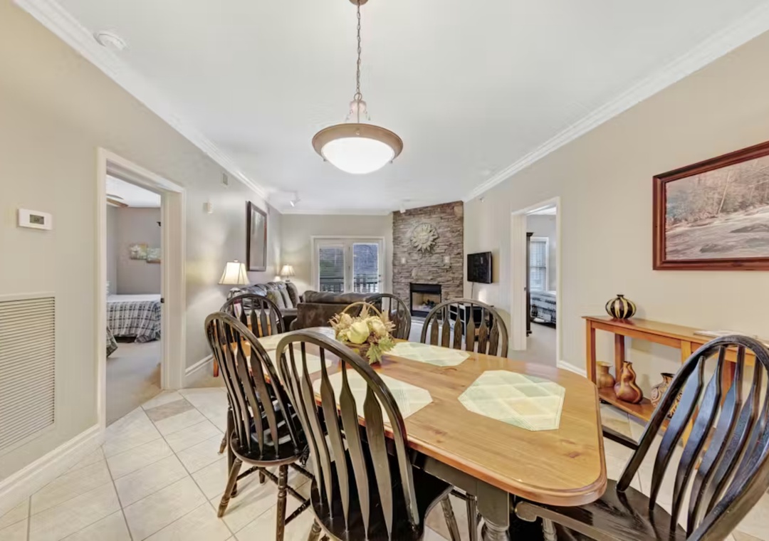 Gather around your spacious dining table for memorable meals, with a cozy fireplace nearby and easy access to comfortable bedrooms.