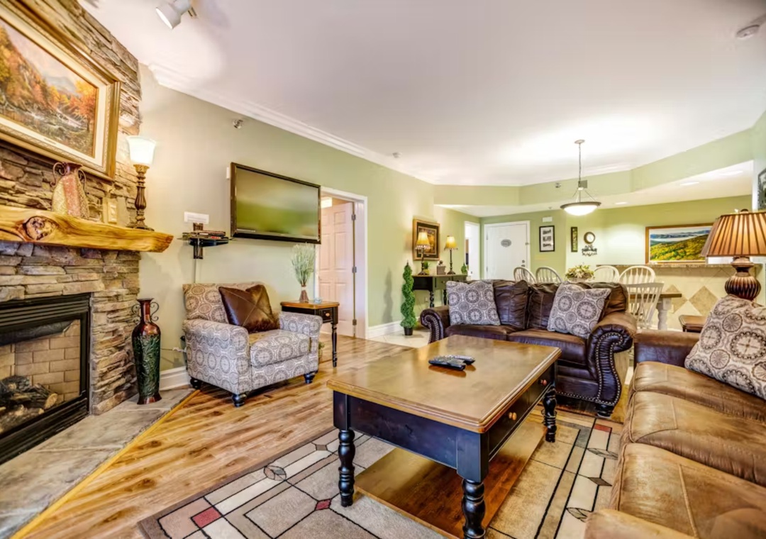 Sink into plush leather sofas by your crackling stone fireplace, where elegant comfort meets homey charm in this welcoming living space.