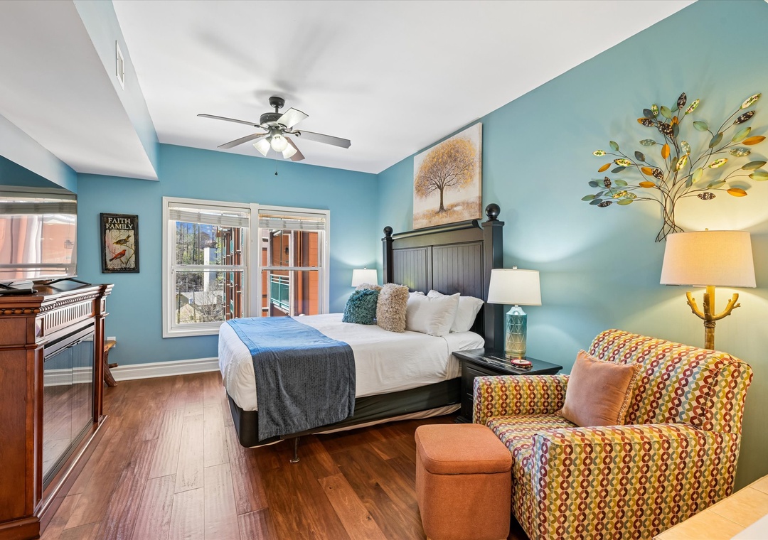 Unwind in your stylish bedroom with soothing turquoise walls, comfortable seating, and peaceful views.