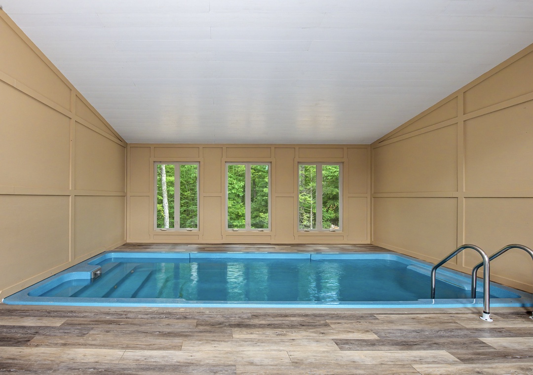Your private indoor pool awaits, surrounded by warm wood panels and flooded with natural light from garden-view windows. Dive into tranquil relaxation steps from your room.