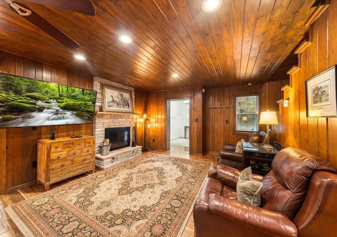 Settle into rich leather seating beneath warm wood-paneled ceilings, where your cozy fireplace creates the perfect ambiance for unwinding after a day of exploring.