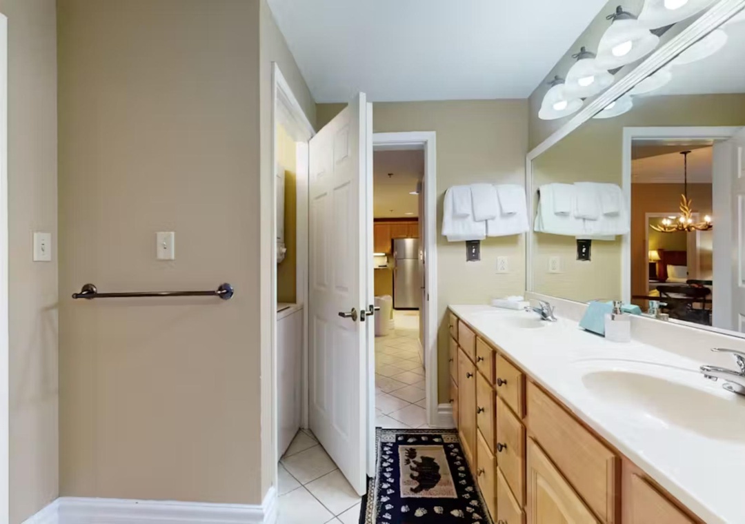 Unwind in your spacious bathroom featuring dual vanities, perfect lighting, and fresh towels ready for your arrival.