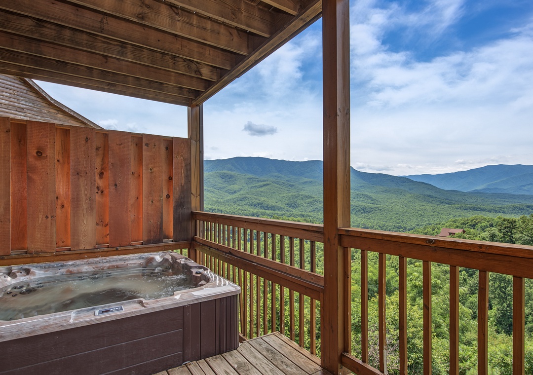 Soak in breathtaking mountain panoramas from your private hot tub, where forest-covered peaks stretch endlessly beneath an open sky—your perfect retreat for relaxation and rejuvenation.