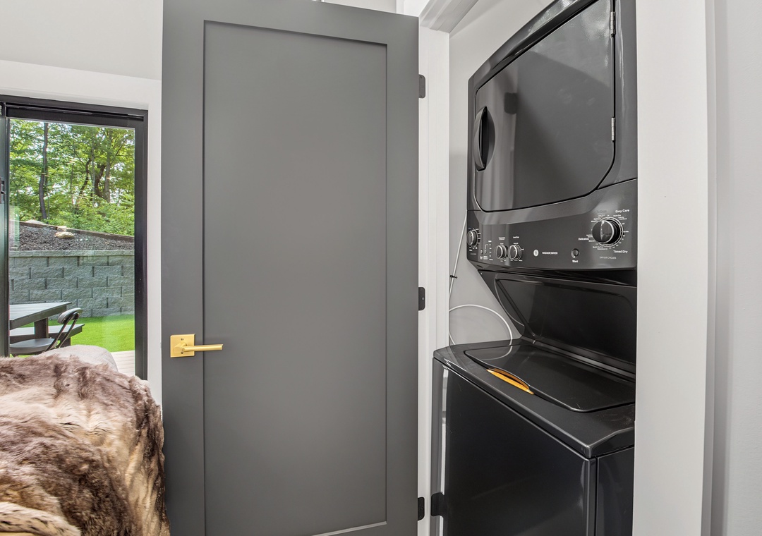 You'll appreciate the convenience of in-unit laundry with this sleek, stacked washer and dryer tucked into a dedicated closet space—perfect for keeping your vacation wardrobe fresh.