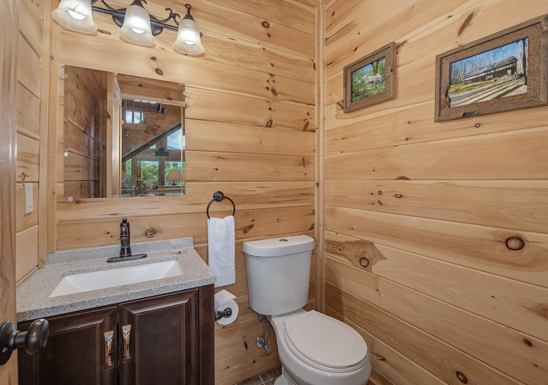 Step into your private bathroom with warm wood walls, granite vanity, and rustic charm that makes every refresh feel like a retreat.