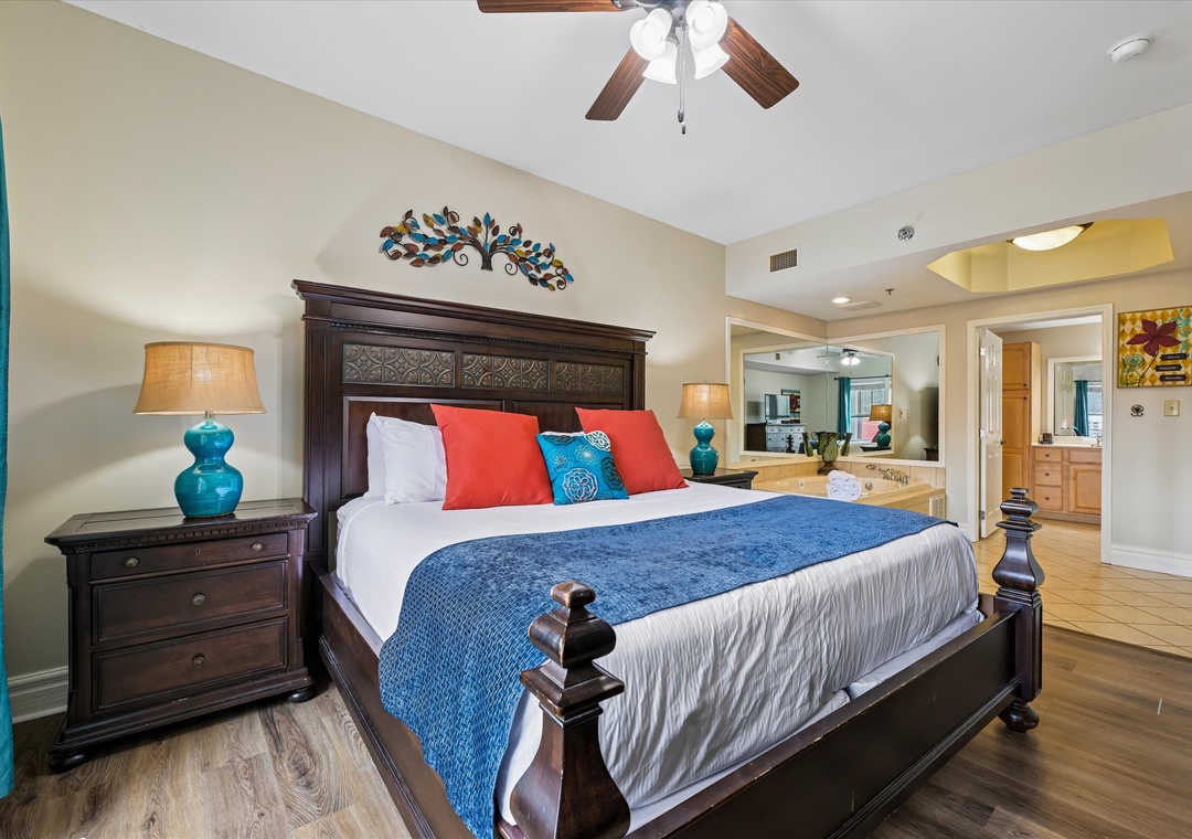 Unwind in your stylish bedroom with elegant dark wood furnishings, vibrant coral and turquoise accents, and thoughtful touches that create a warm, welcoming retreat.