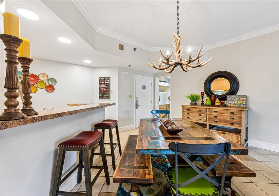 Your stylish dining space features rustic wood furniture, antler chandelier, and breakfast bar—perfect for memorable meals together.