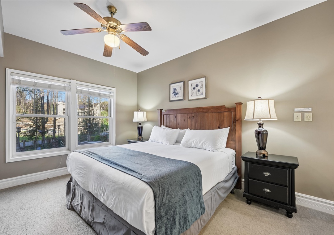 Slip into crisp linens in your peaceful bedroom, where ceiling fans keep you cool and forest views create your perfect morning backdrop.