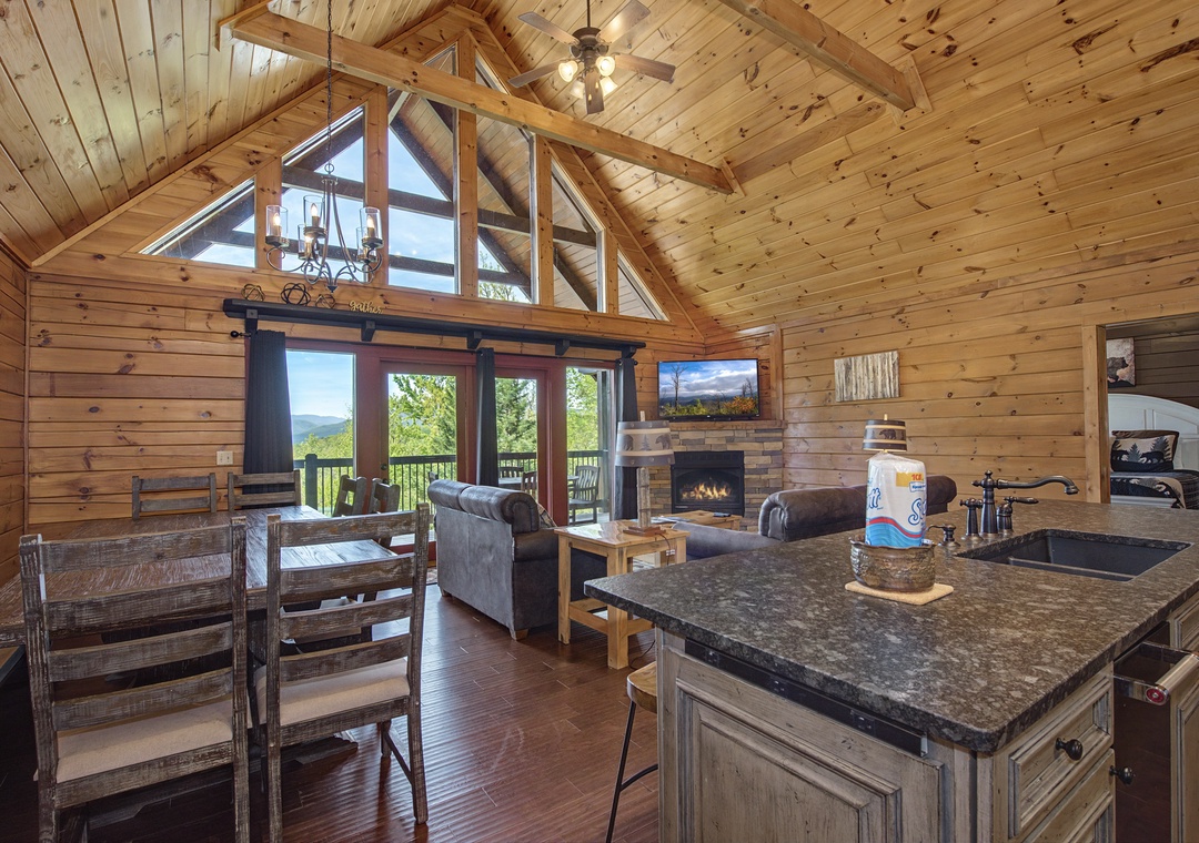 Relax in your rustic log cabin with soaring ceilings, cozy fireplace, and mountain views from the deck.