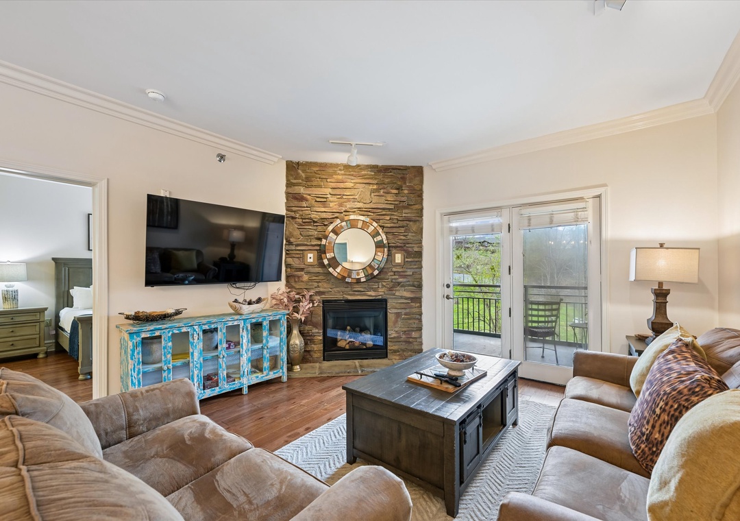 Sink into plush sofas by your stone fireplace, where warm evenings unfold with your favorite shows and balcony views.