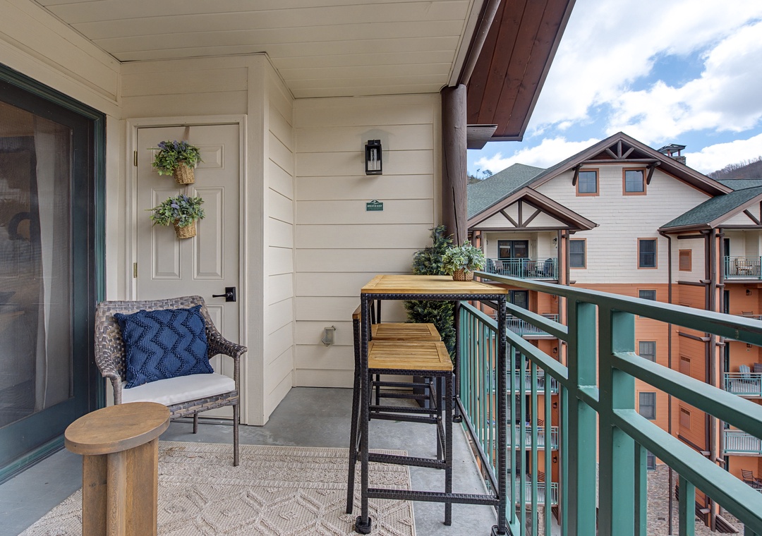 Step onto your private balcony for morning coffee with mountain views. Cozy seating and bistro table create the perfect spot to unwind.