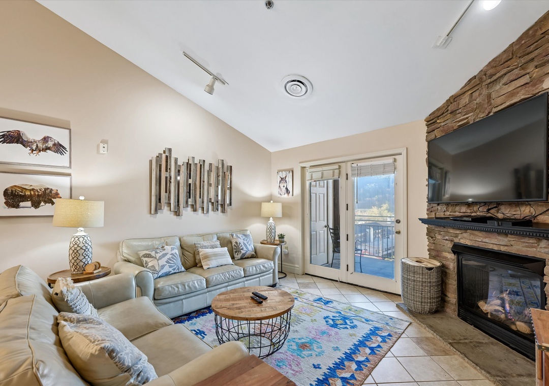 Sink into plush sofas by your crackling fireplace, where mountain views frame cozy evenings in this thoughtfully appointed living space.