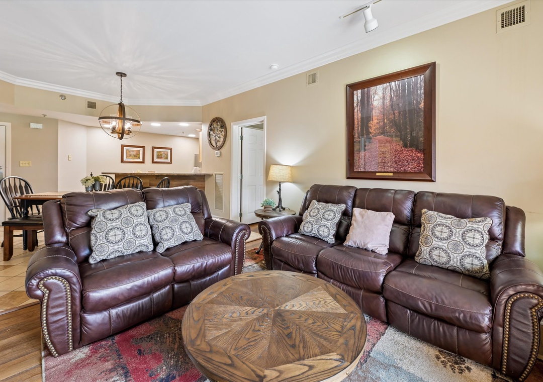 Sink into luxurious leather seating while you enjoy your morning coffee in this warm, inviting living space.